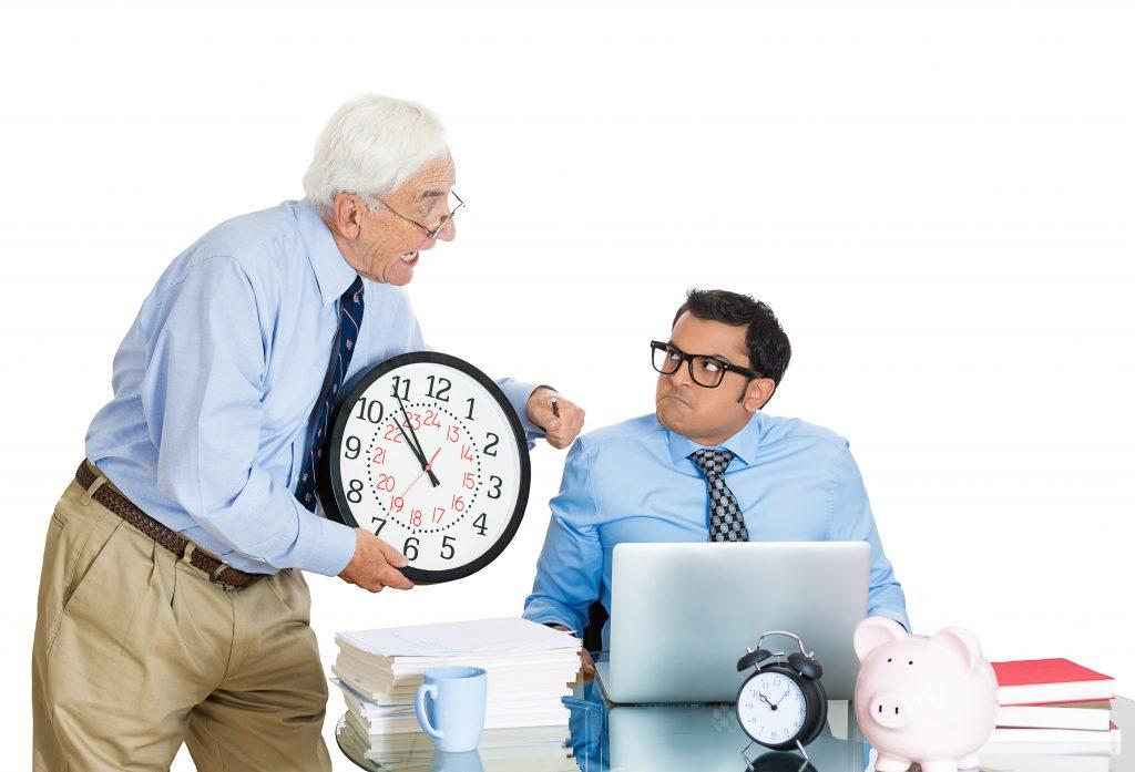 a man holding a clock next to a piggy bank