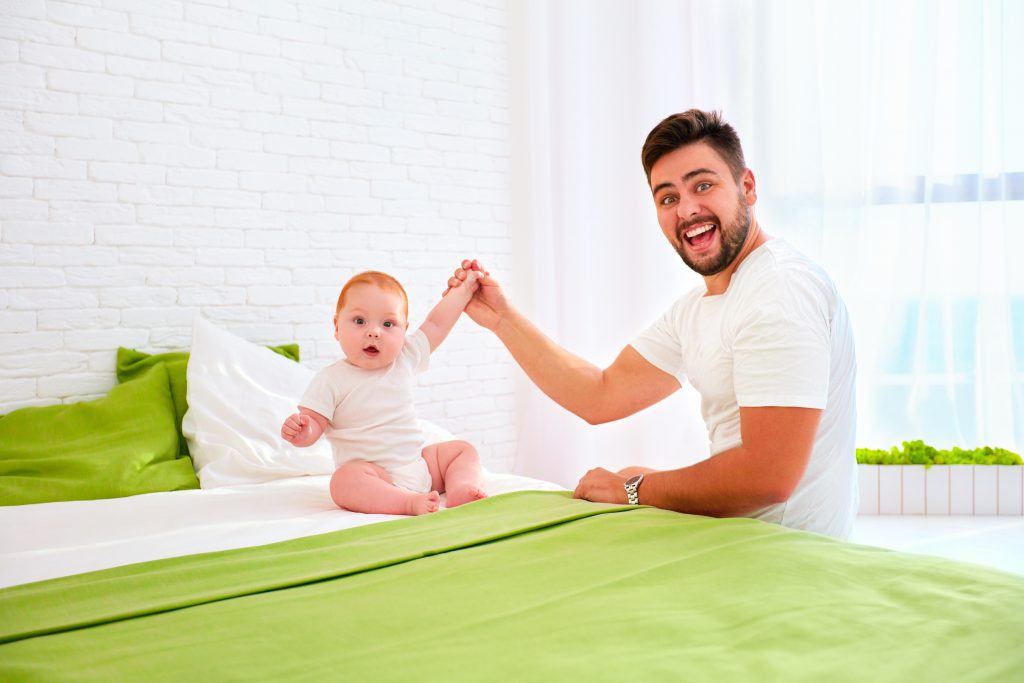 ivf coverage law image of man with a baby