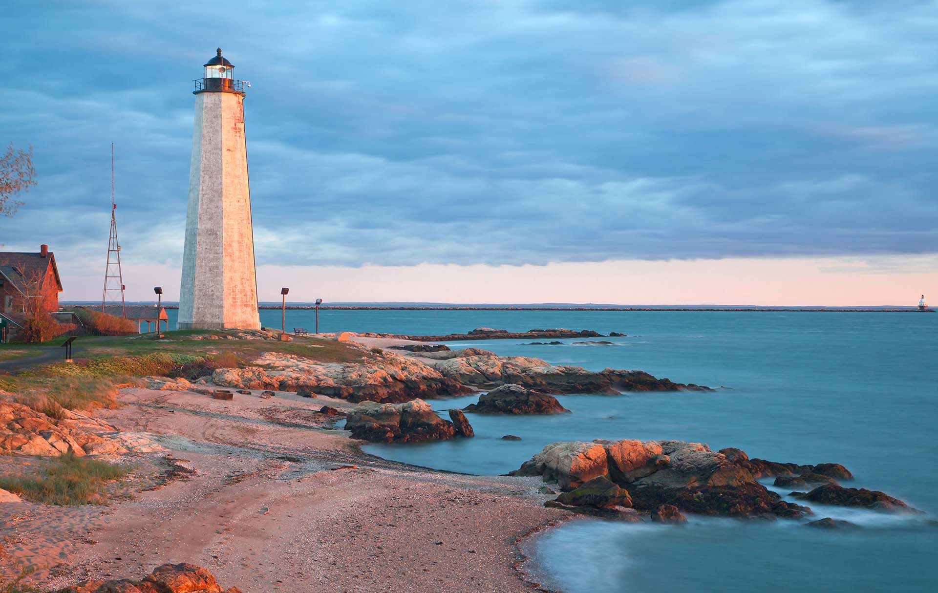 a light house sitting on top of a rocky shore