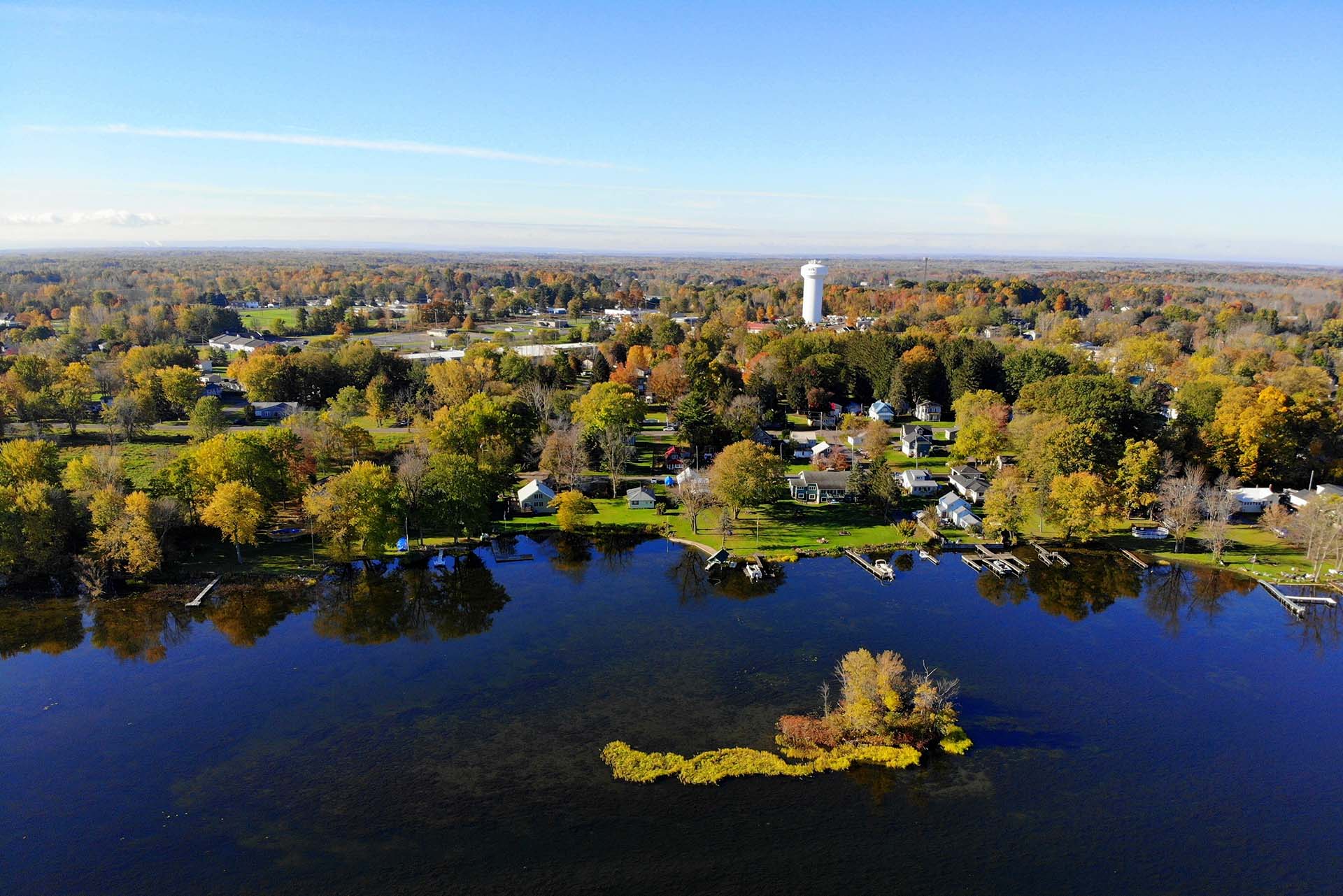 an aerial view of a lake surrounded by trees